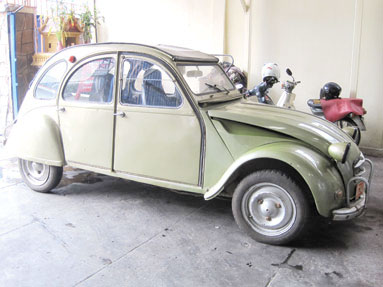 Snapped in Phnom Penh was this battered and venerable Citroen 2CV